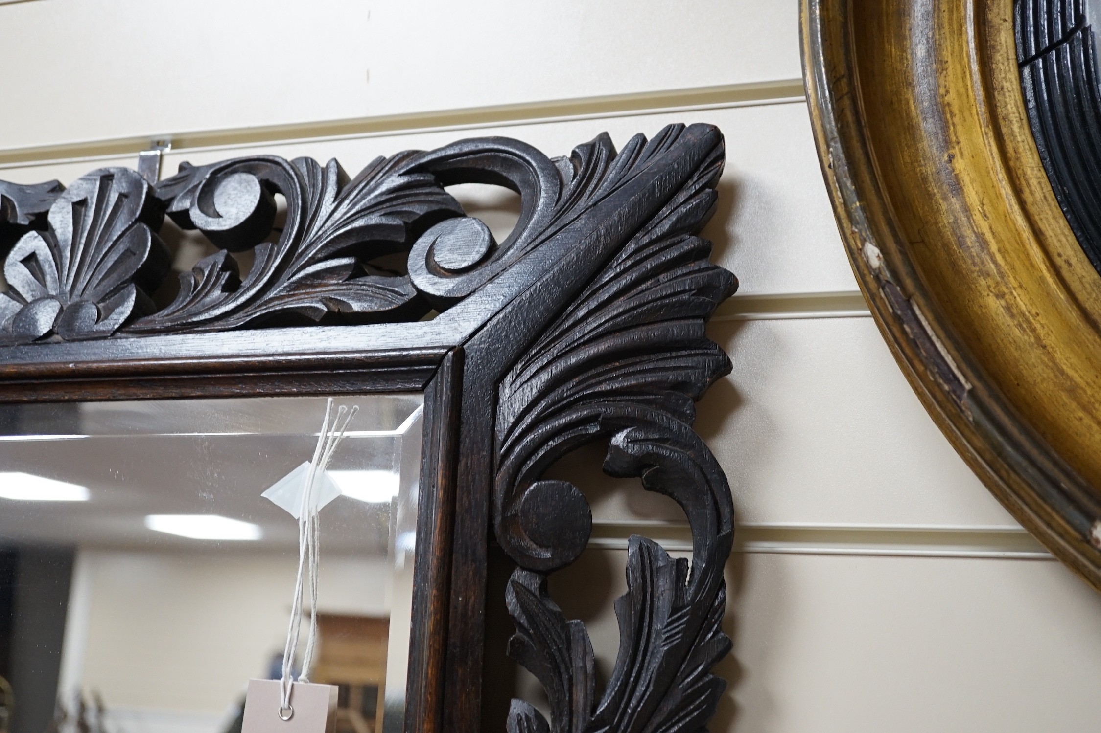 An Edwardian foliate carved oak wall mirror, width 81cm, height 64cm *Please note the sale commences at 9am.